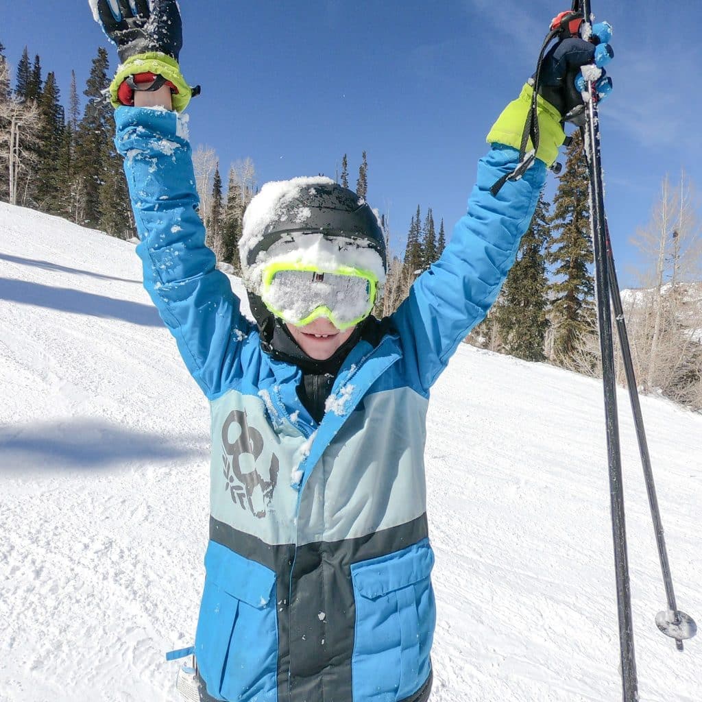 Child skiing with a neck gaiter.