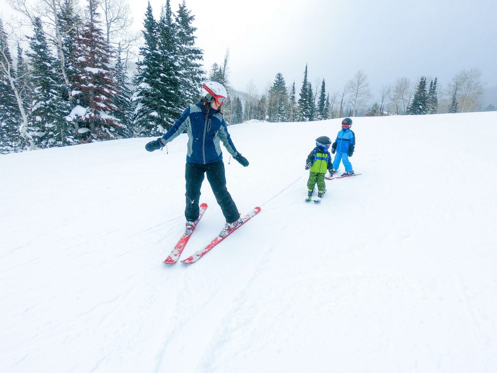 Mom skiing with little boys