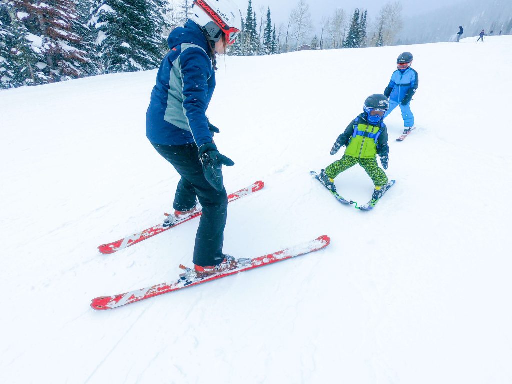 Mom skiing with little boys