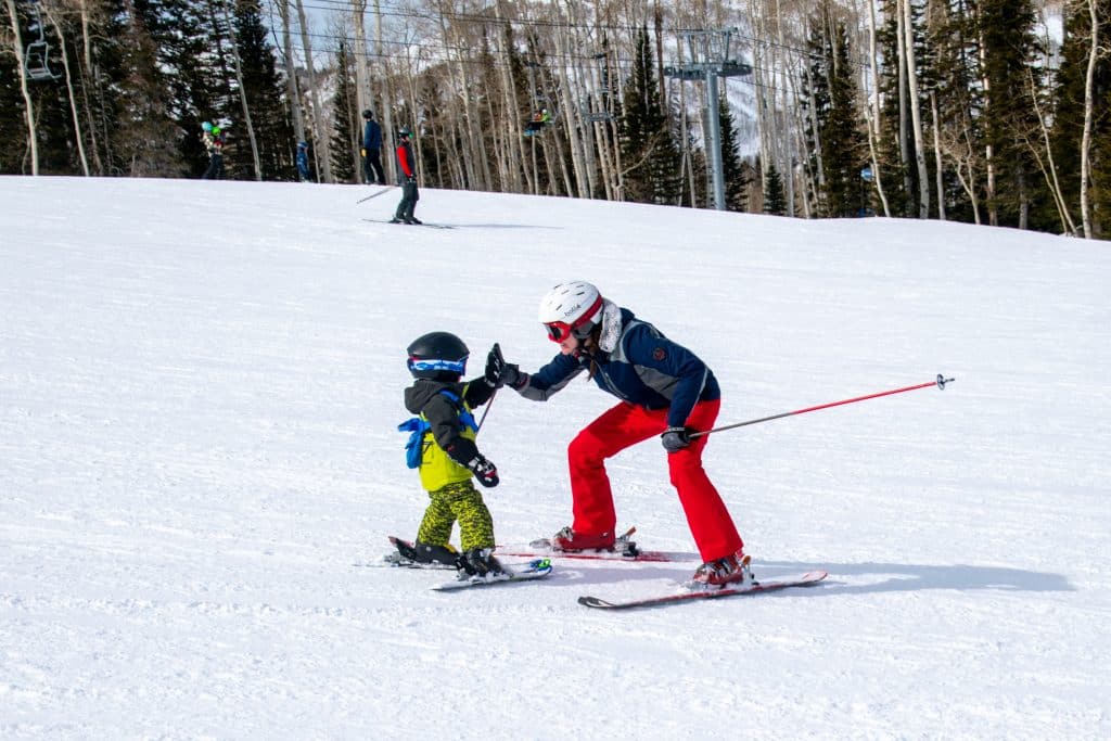 Mom son high five skiing