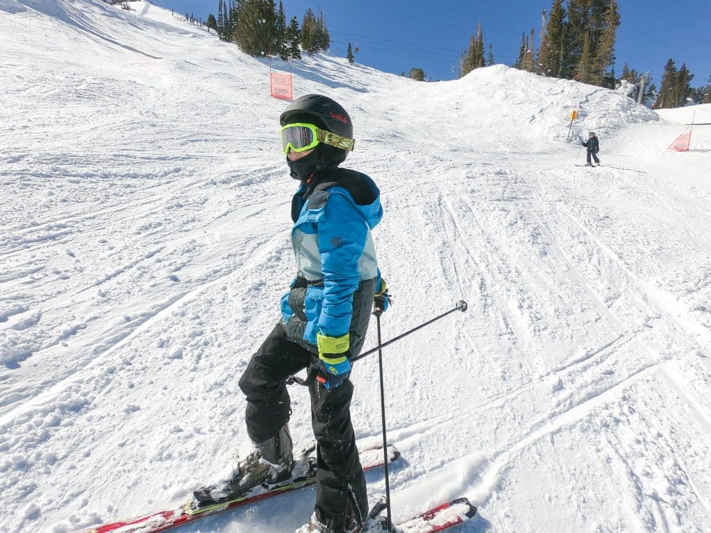 boy skiing wearing balaclava as a ski mask