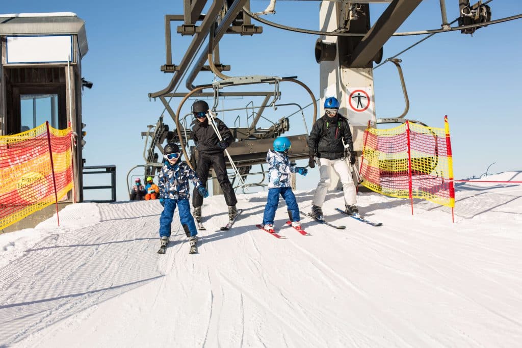 family getting off chairlift