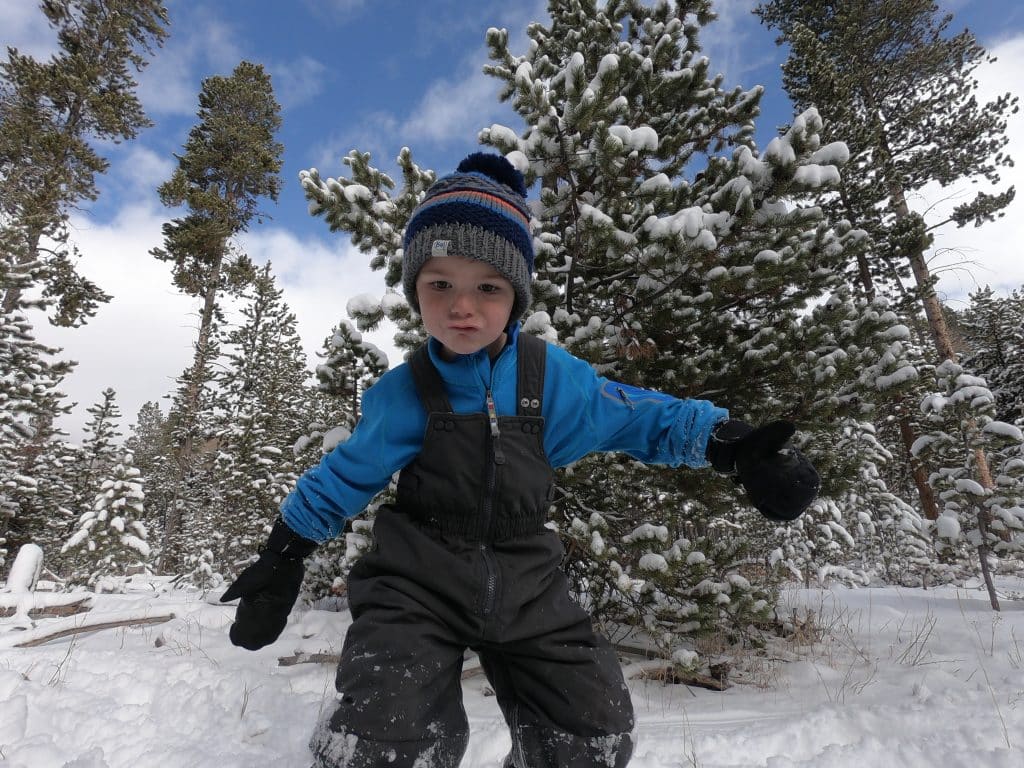 boy Playing in the snow with mittens