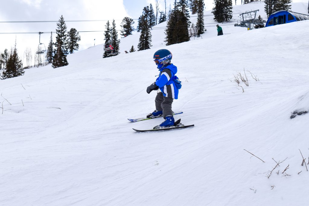 Toddler skiing in spring