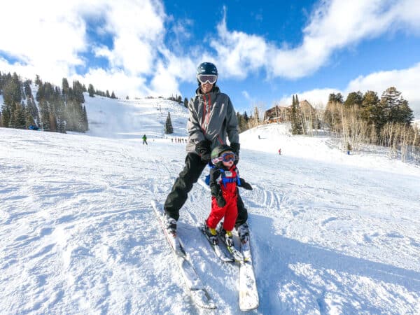 dad and baby skiing together