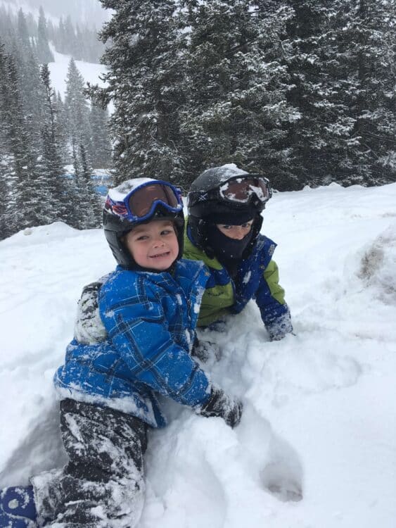 kids playing in snow after skiing at resort with childcare