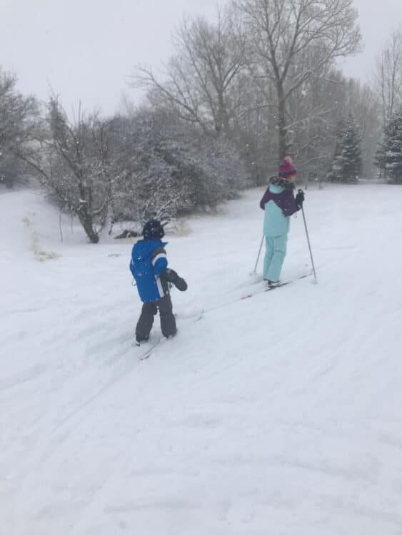 learning to ski without ski poles wearing mittens