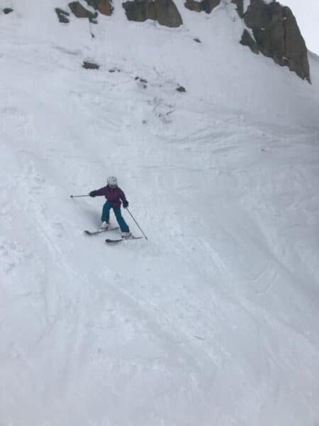 teen girl skiing steep