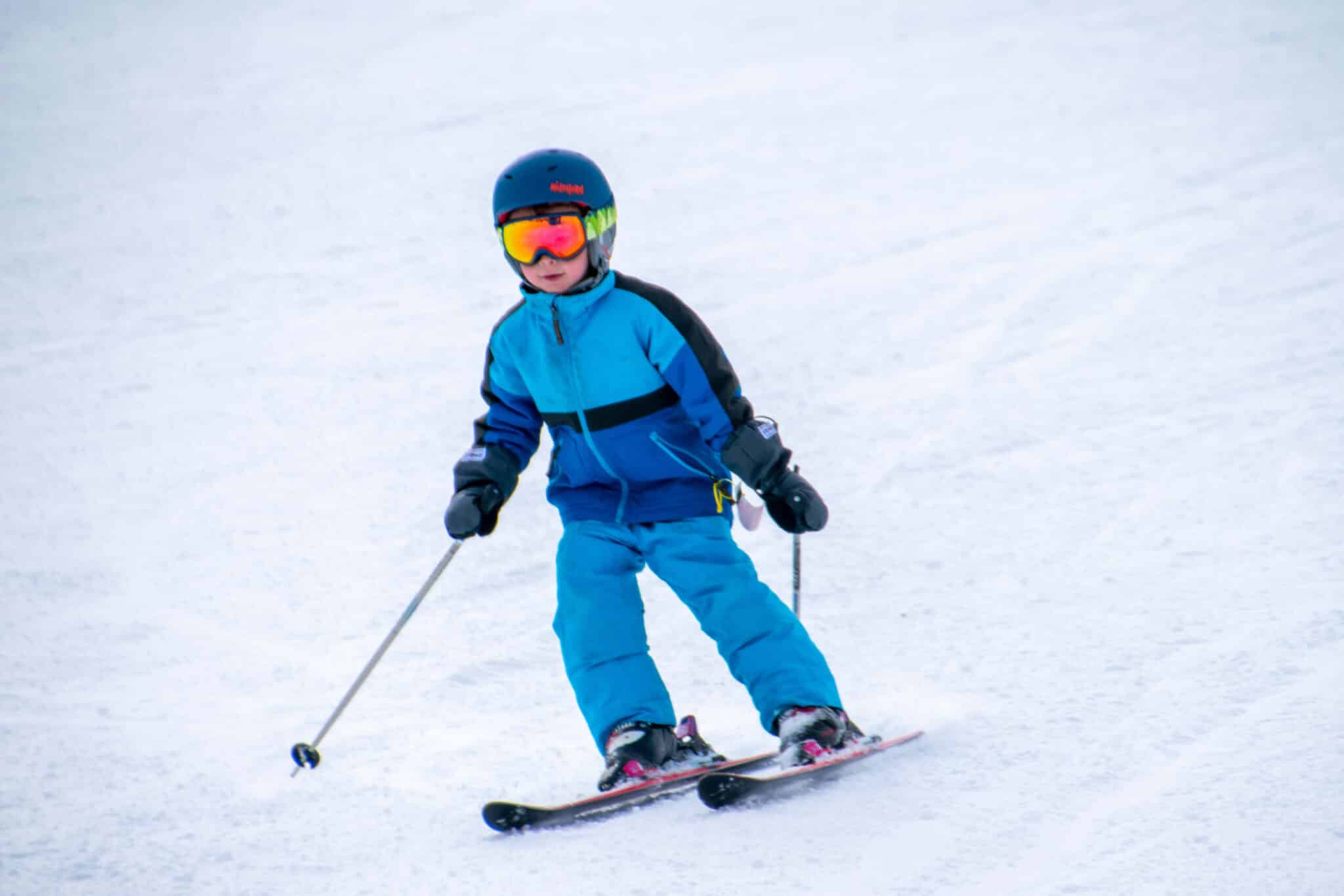 little boy skiing on snow