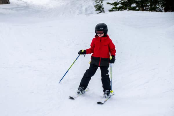 boy skiing with kids ski poles