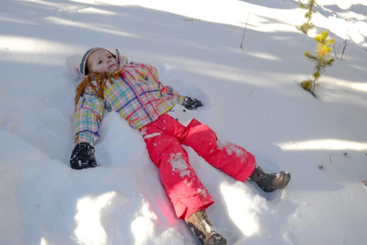 girl making snow angel