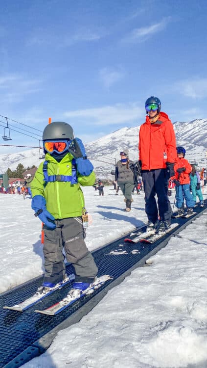 first time skiers at Nordic Valley resort with kids wearing mittens