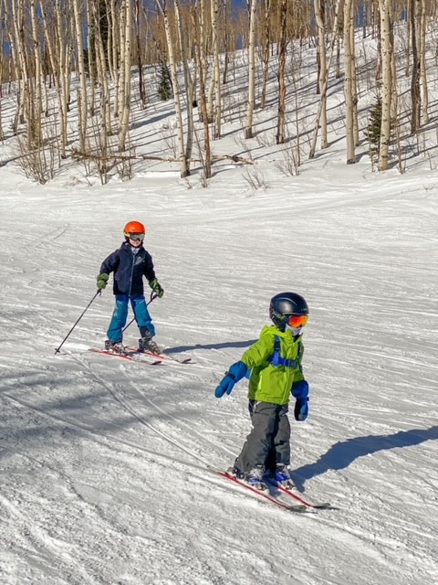 boys skiing with reima mittens on