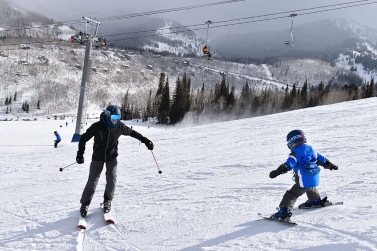 Father and son having fun skiing