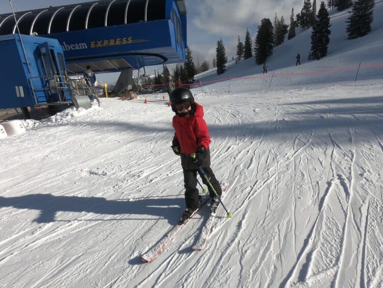 Boy skiing getting off a ski lift