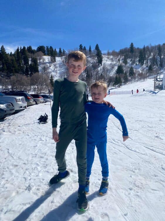 Brothers in base layers getting ready for skiing