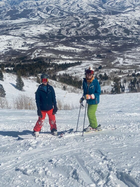 Brother and sister skiing and snowboarding