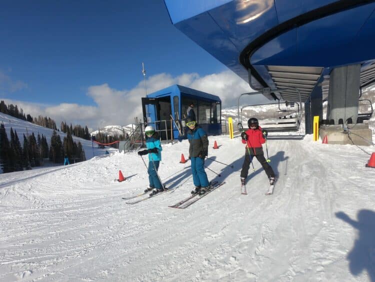 Kids getting off ski lift skiing