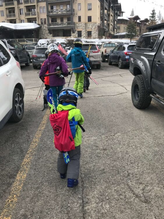 family with ski backpacks