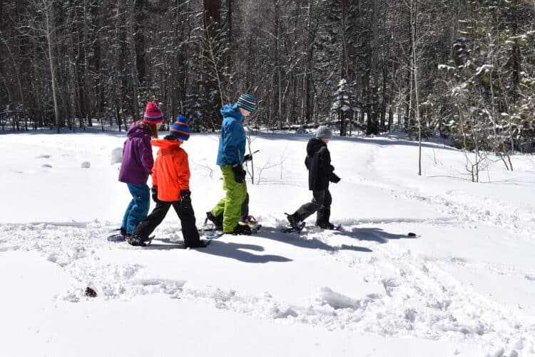 kids in snow wearing snow hats for winter