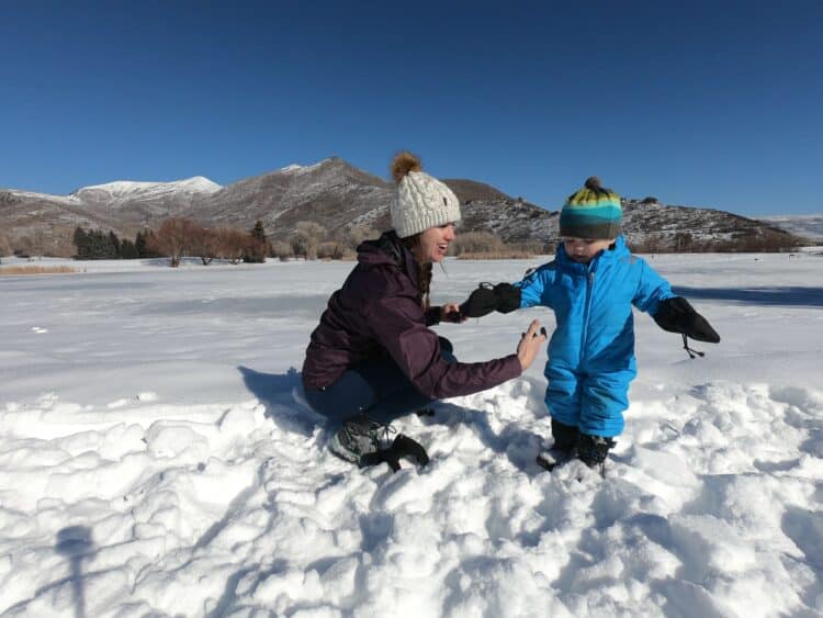 mom and baby in the snow wearing hats