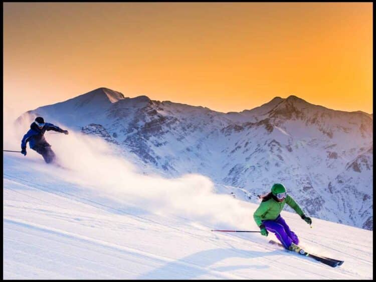 skiers at sunset