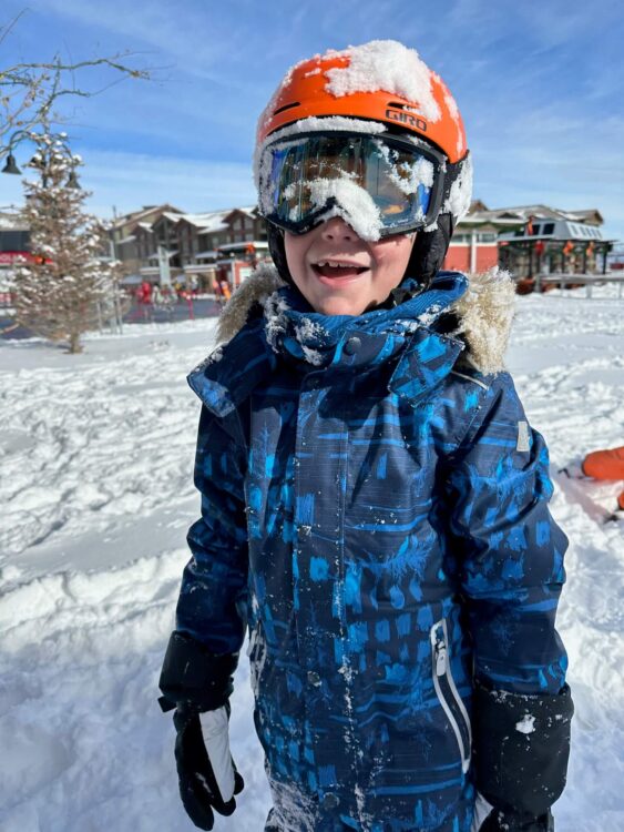 kids in the snow with a helmet on