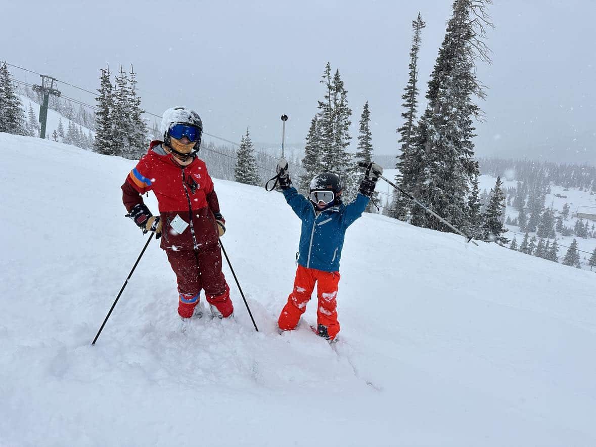 family skiing at brianhead utah powder day