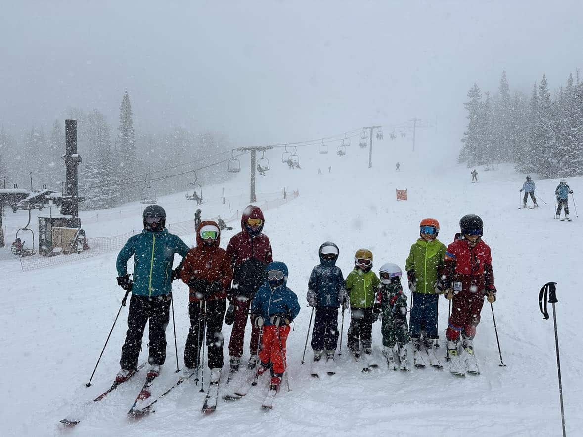 family skiing at brianhead utah powder day