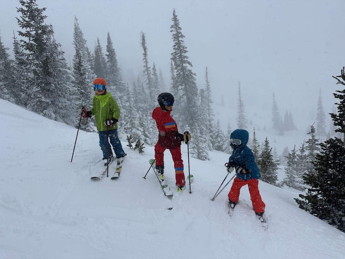 family skiing at brianhead utah powder day