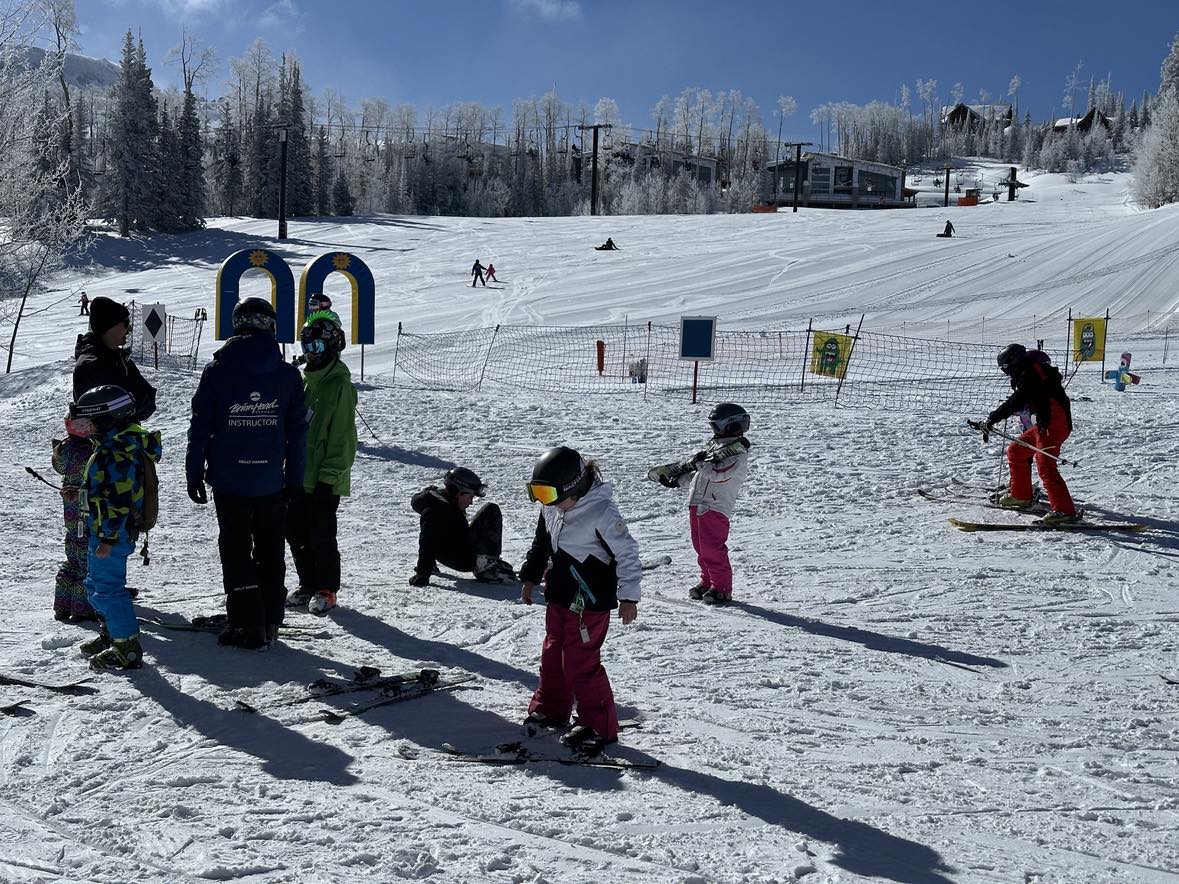 family skiing at brianhead utah powder day